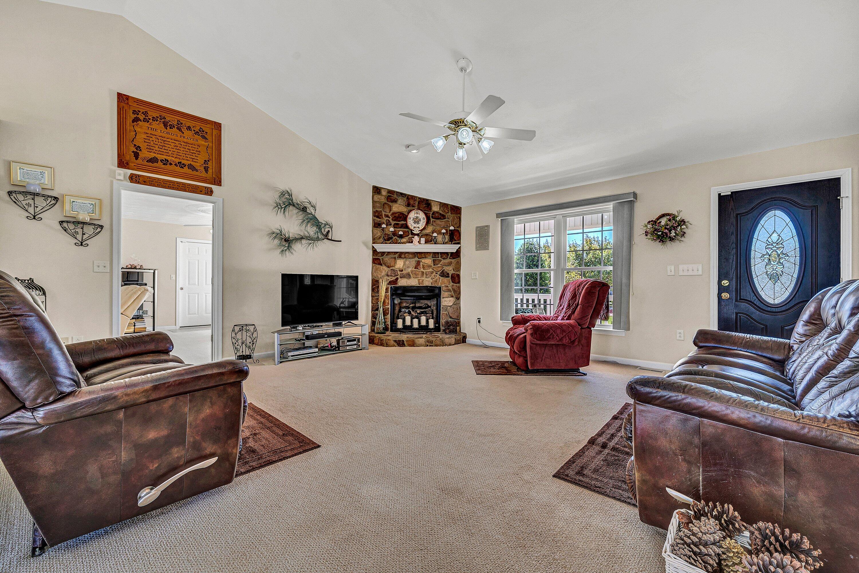 1850 Emmaus Church Road Moneta, VA 24121 - Photo 5 of 63 a living room with furniture a fireplace and a flat screen tv