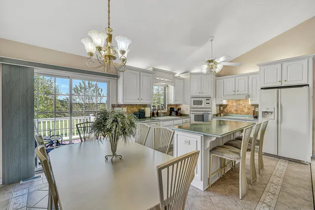 a kitchen with cabinets appliances a sink and a window