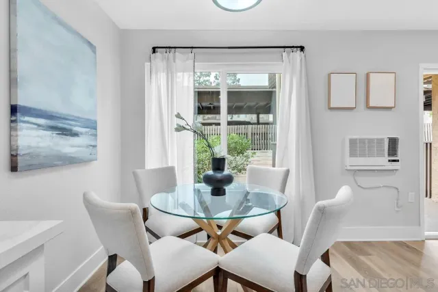 a dining room with furniture and window
