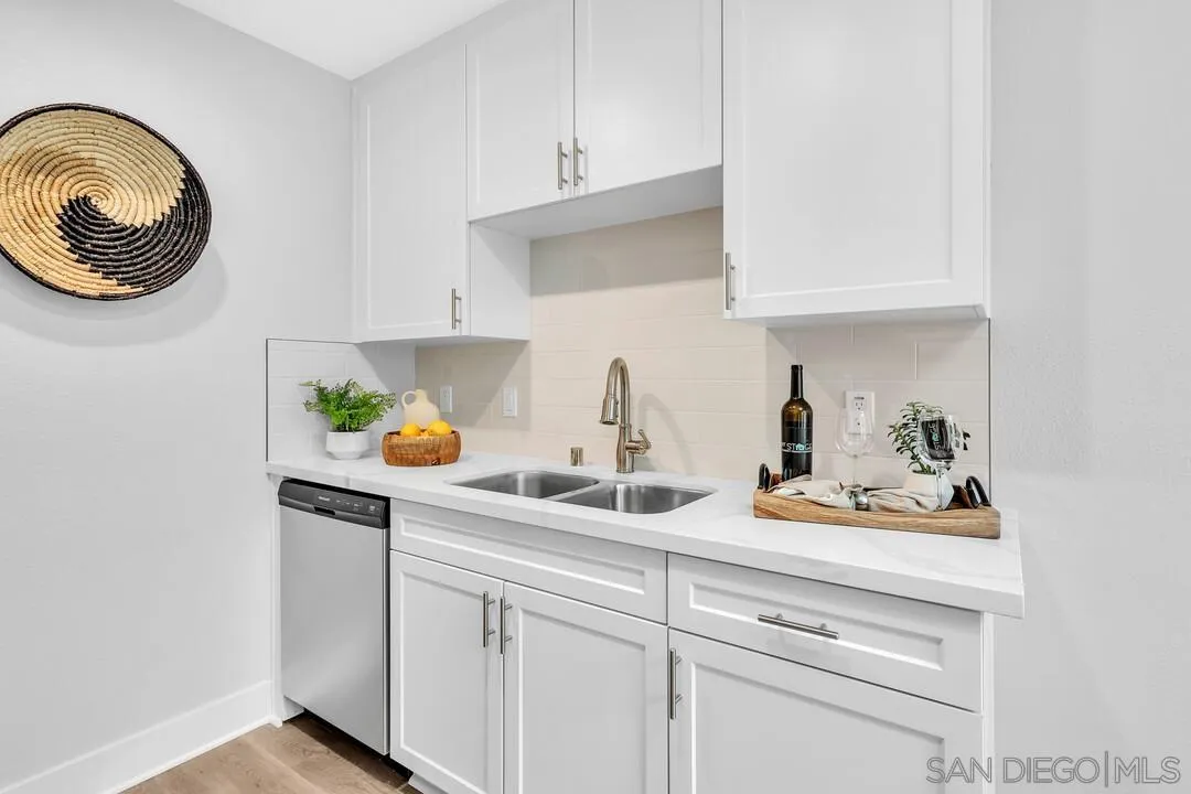 8644 Via Mallorca, Unit F La Jolla, CA 92037 - Photo 17 of 34 a kitchen with white cabinets and a sink