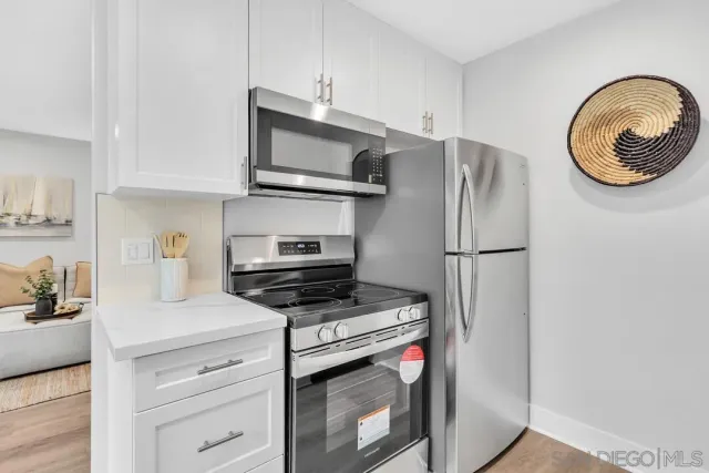 a kitchen with stainless steel appliances a stove microwave and a refrigerator