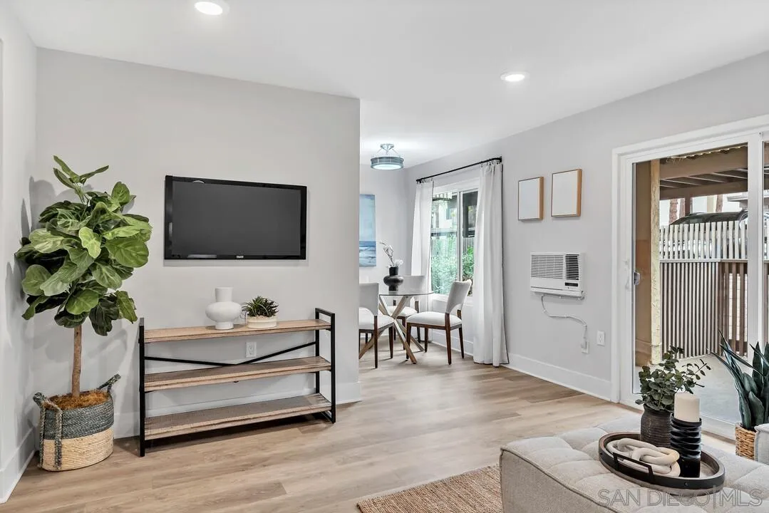 8644 Via Mallorca, Unit F La Jolla, CA 92037 - Photo 4 of 34 a living room with furniture potted plant and a flat screen tv