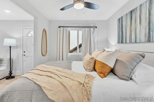 a bedroom with a large bed and a chandelier