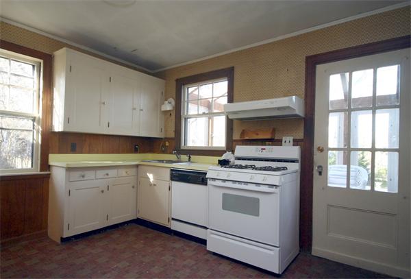 14 Woodleigh Road Dedham, MA 02026 - Photo 16 of 24 a kitchen with a stove and white cabinets