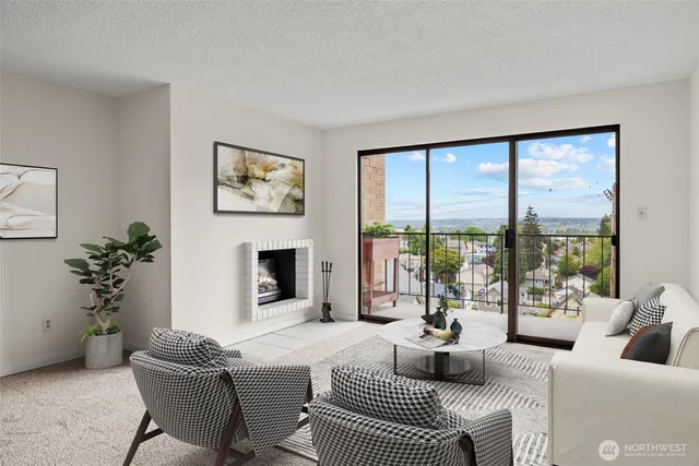a living room with furniture a floor to ceiling window and a fireplace