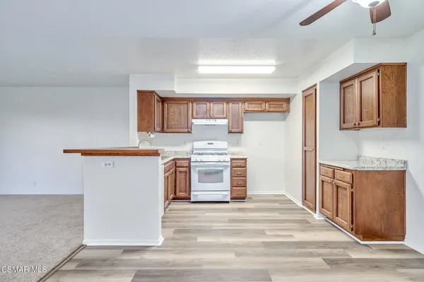 a kitchen with stainless steel appliances white cabinets and wooden floor