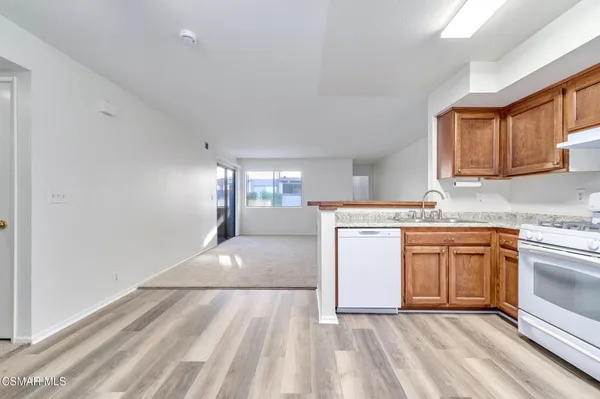 a kitchen with stainless steel appliances granite countertop a sink stove and cabinets