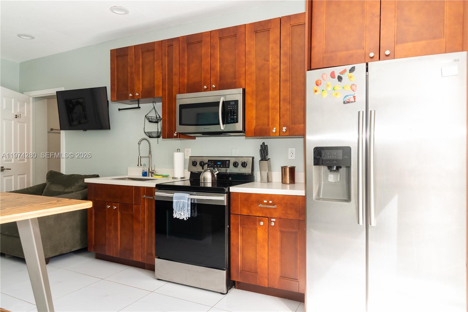 3134 Carter Street Miami, FL 33133 - Photo 18 of 36 a kitchen with stainless steel appliances a stove microwave and refrigerator
