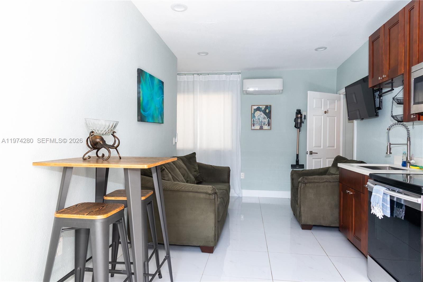 3134 Carter Street Miami, FL 33133 - Photo 19 of 36 a living room with furniture and a flat screen tv
