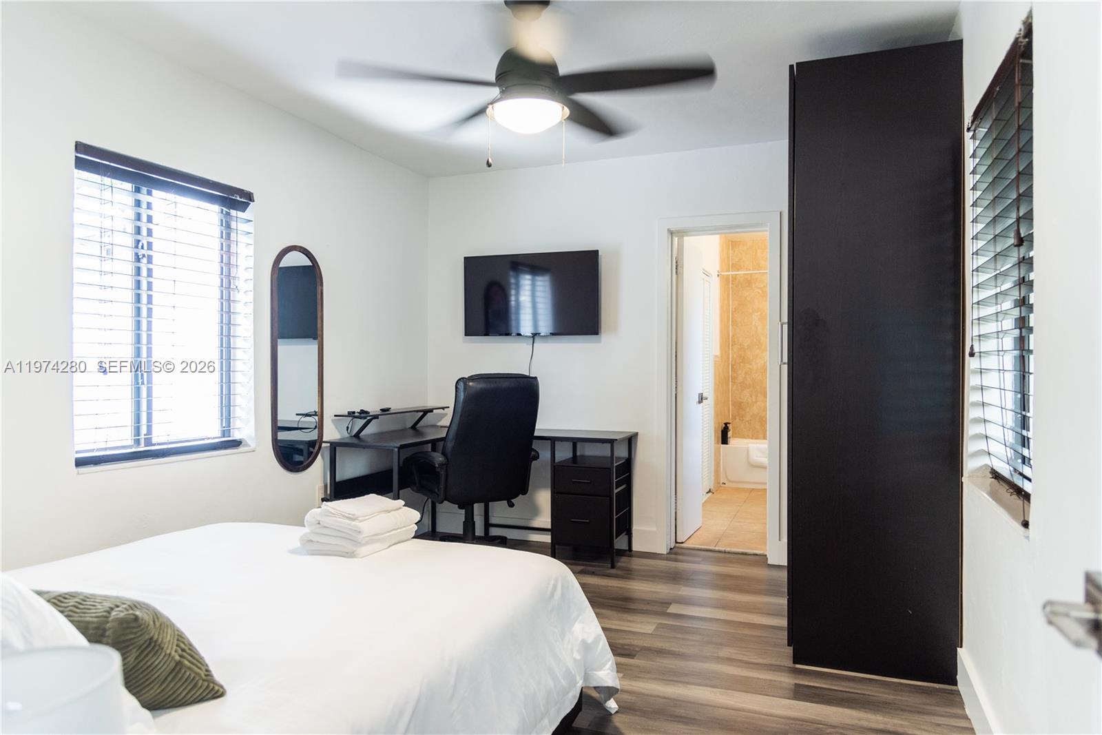 3134 Carter Street Miami, FL 33133 - Photo 24 of 36 a bedroom with a bed and a desk