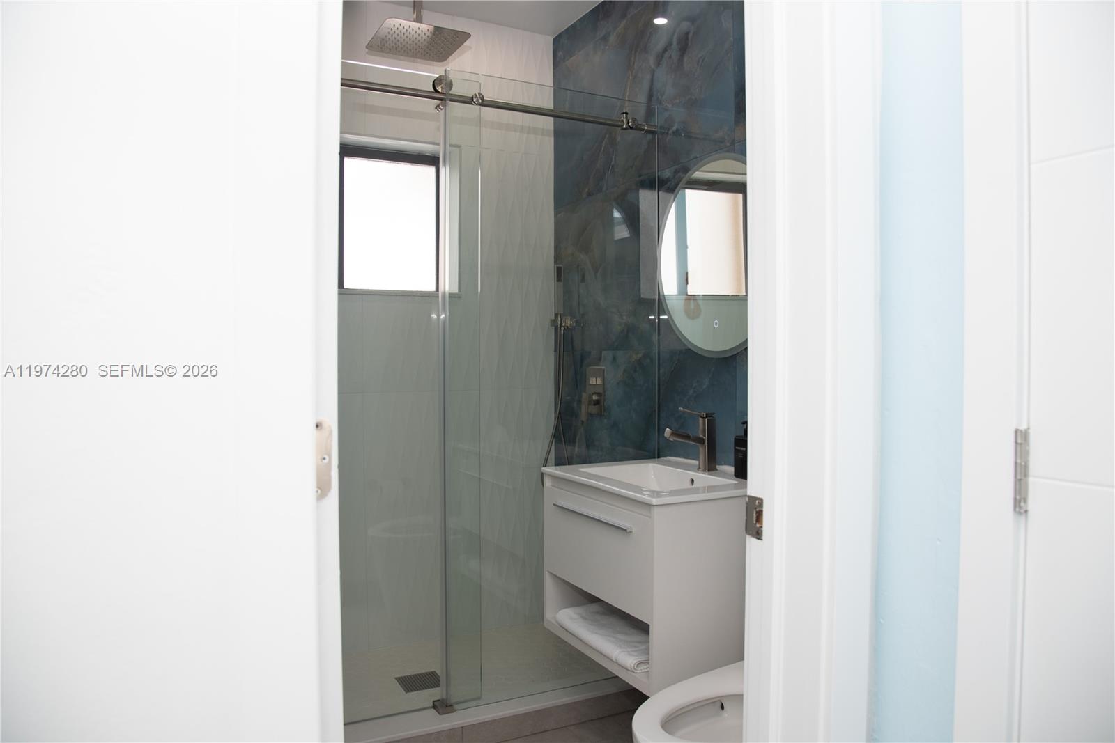 3134 Carter Street Miami, FL 33133 - Photo 28 of 36 a bathroom with a sink a toilet and shower