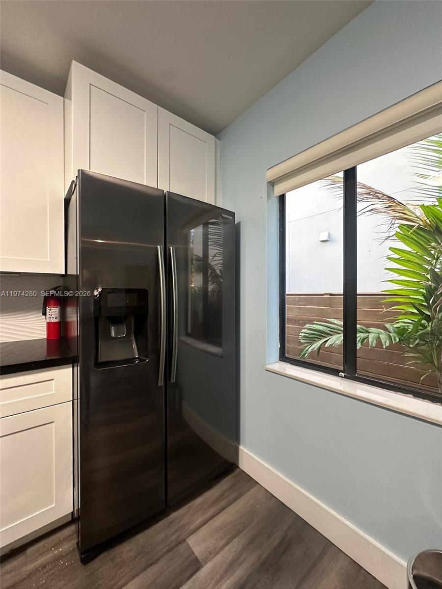 3134 Carter Street Miami, FL 33133 - Photo 4 of 36 a kitchen with a refrigerator and window