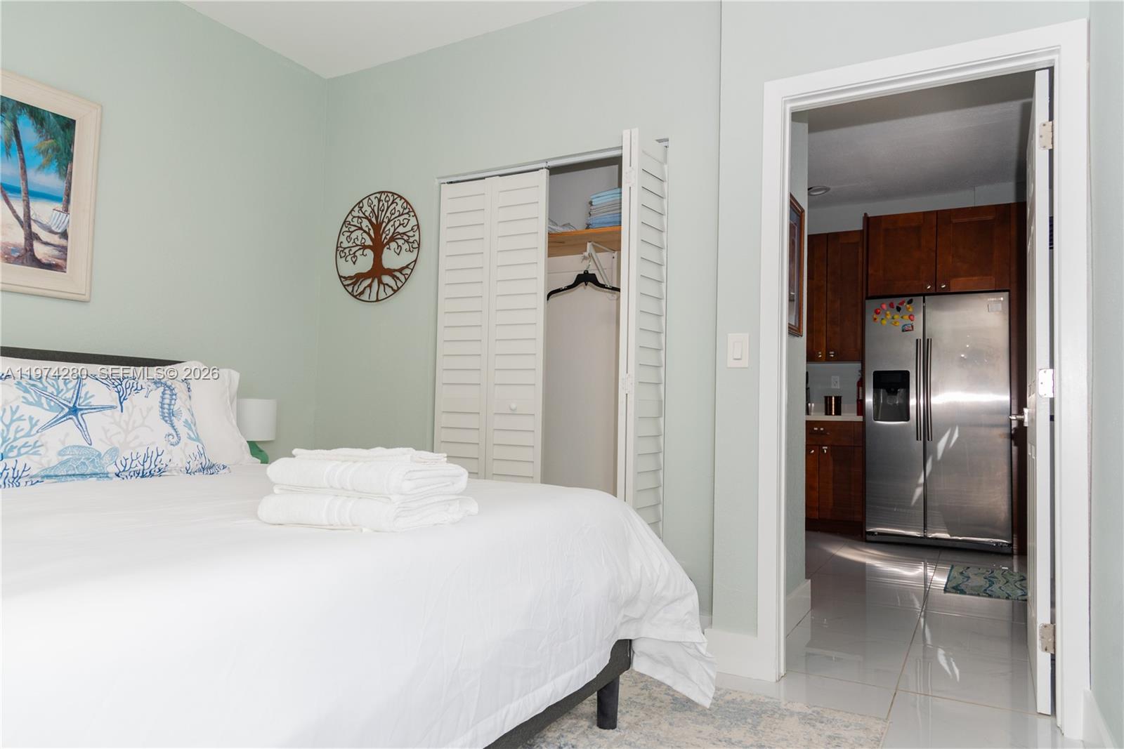 3134 Carter Street Miami, FL 33133 - Photo 10 of 36 a bedroom with a bed and a lamp