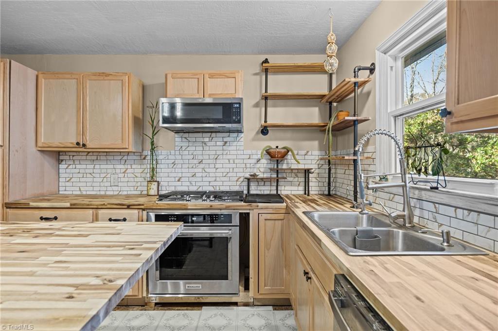 931 Ransom Road Winston-Salem, NC 27106 - Photo 15 of 48 Kitchen with island, stainless steel appliances and lots of cabinet storages.