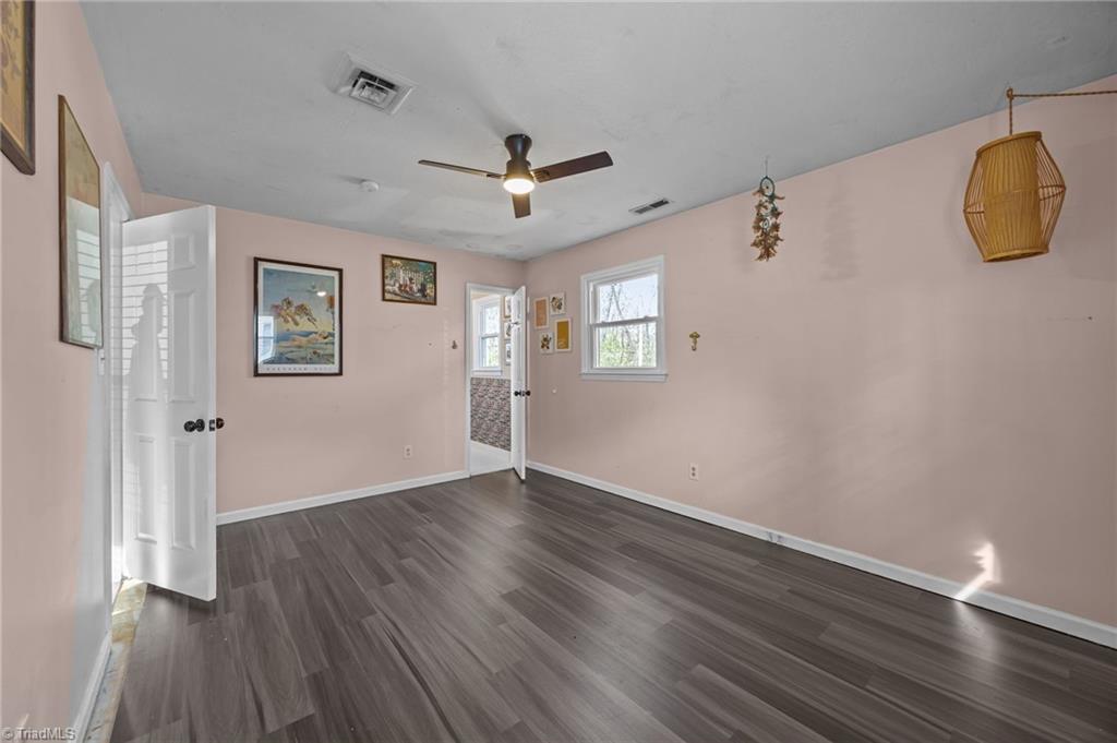931 Ransom Road Winston-Salem, NC 27106 - Photo 18 of 48 Primary bedroom with an attached primary bath and ceiling fan.