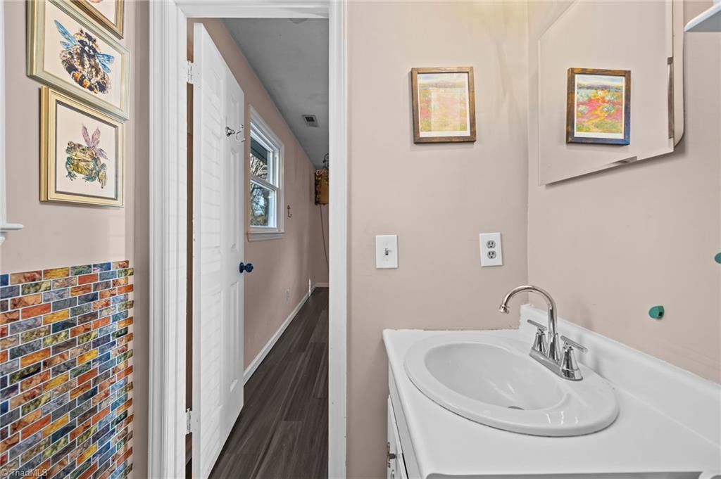 931 Ransom Road Winston-Salem, NC 27106 - Photo 19 of 48 Ensuite primary bathroom with single vanity and standalone shower.