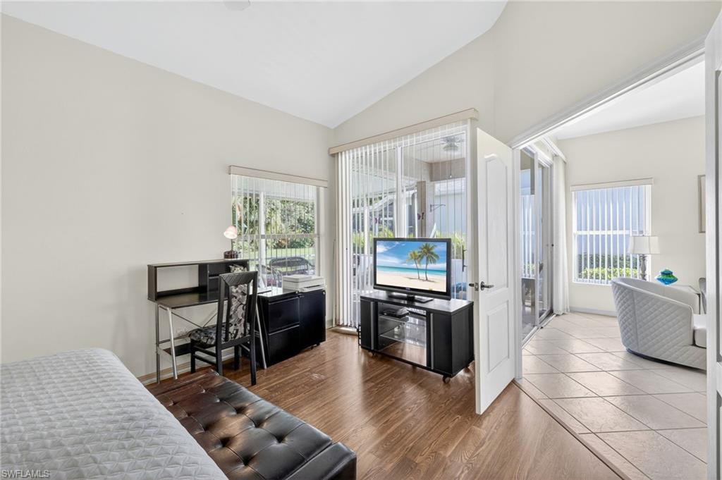 20818 Blacksmith Estero, FL 33928 - Photo 12 of 21 a living room with furniture a fireplace a flat screen tv and wooden floor