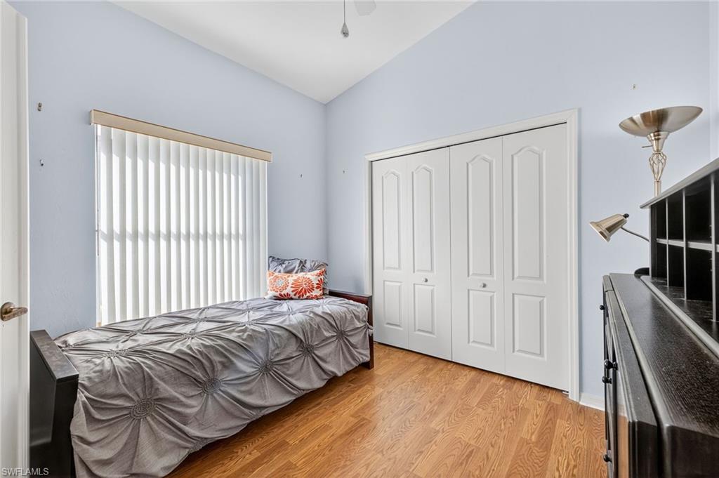 20818 Blacksmith Estero, FL 33928 - Photo 15 of 21 a bedroom with a bed and a flat tv screen on a dresser