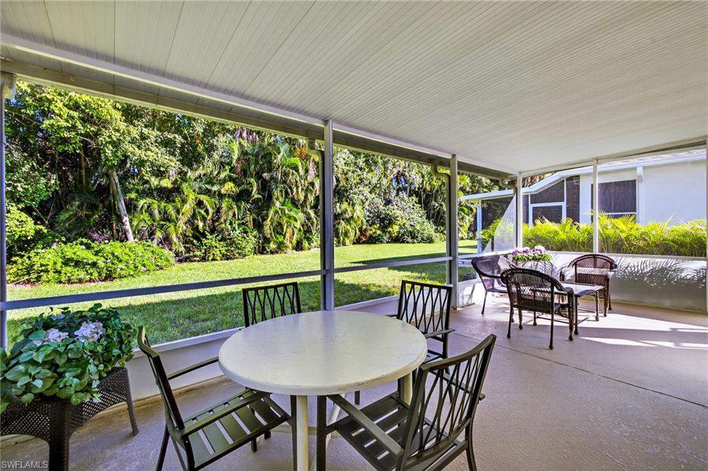 20818 Blacksmith Estero, FL 33928 - Photo 17 of 21 a view of a patio with a table chairs and a backyard