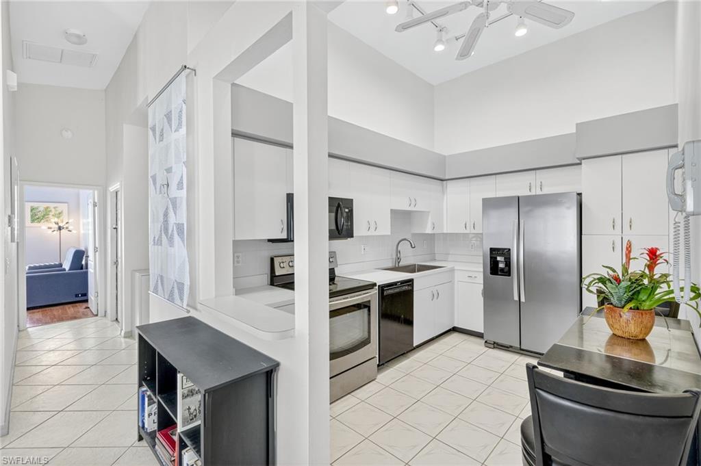 20818 Blacksmith Estero, FL 33928 - Photo 4 of 21 a kitchen with white cabinets and stainless steel appliances