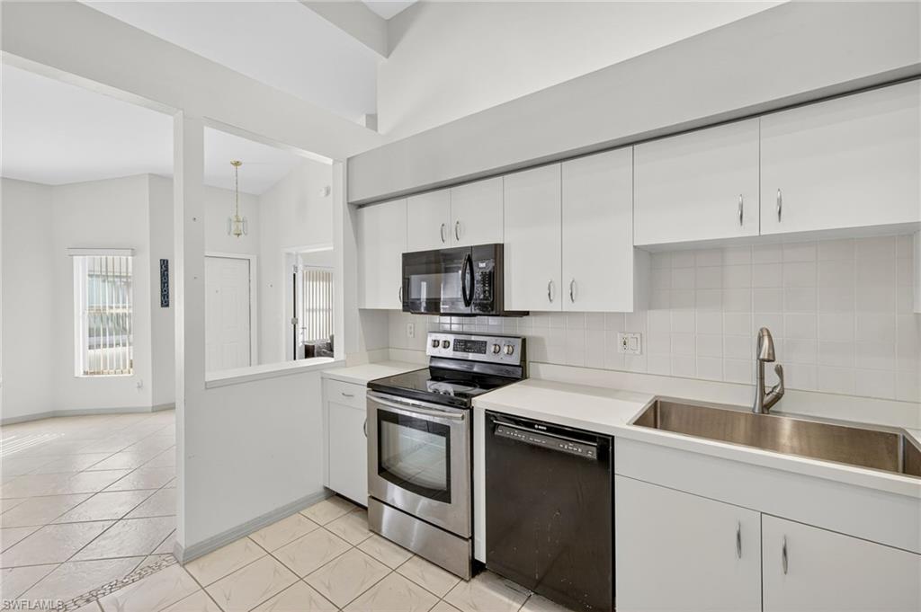 20818 Blacksmith Estero, FL 33928 - Photo 10 of 21 a kitchen with cabinets stainless steel appliances and a sink