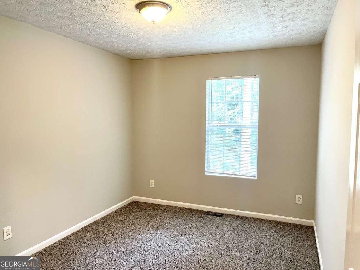 5594 Fair Creek Way Lithonia, GA 30038 - Photo 11 of 15 an empty room with a window