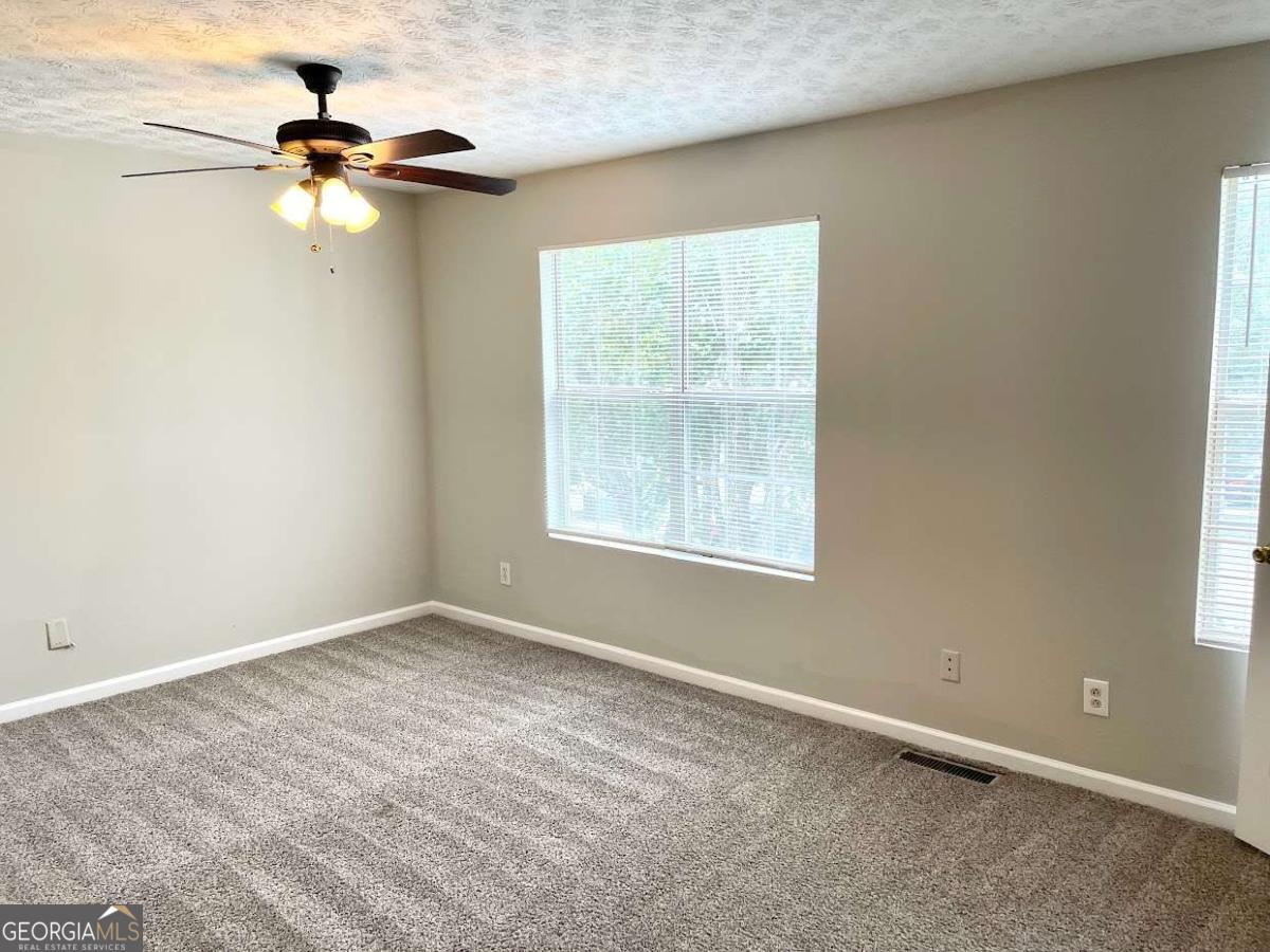 5594 Fair Creek Way Lithonia, GA 30038 - Photo 14 of 15 a view of an empty room with a window