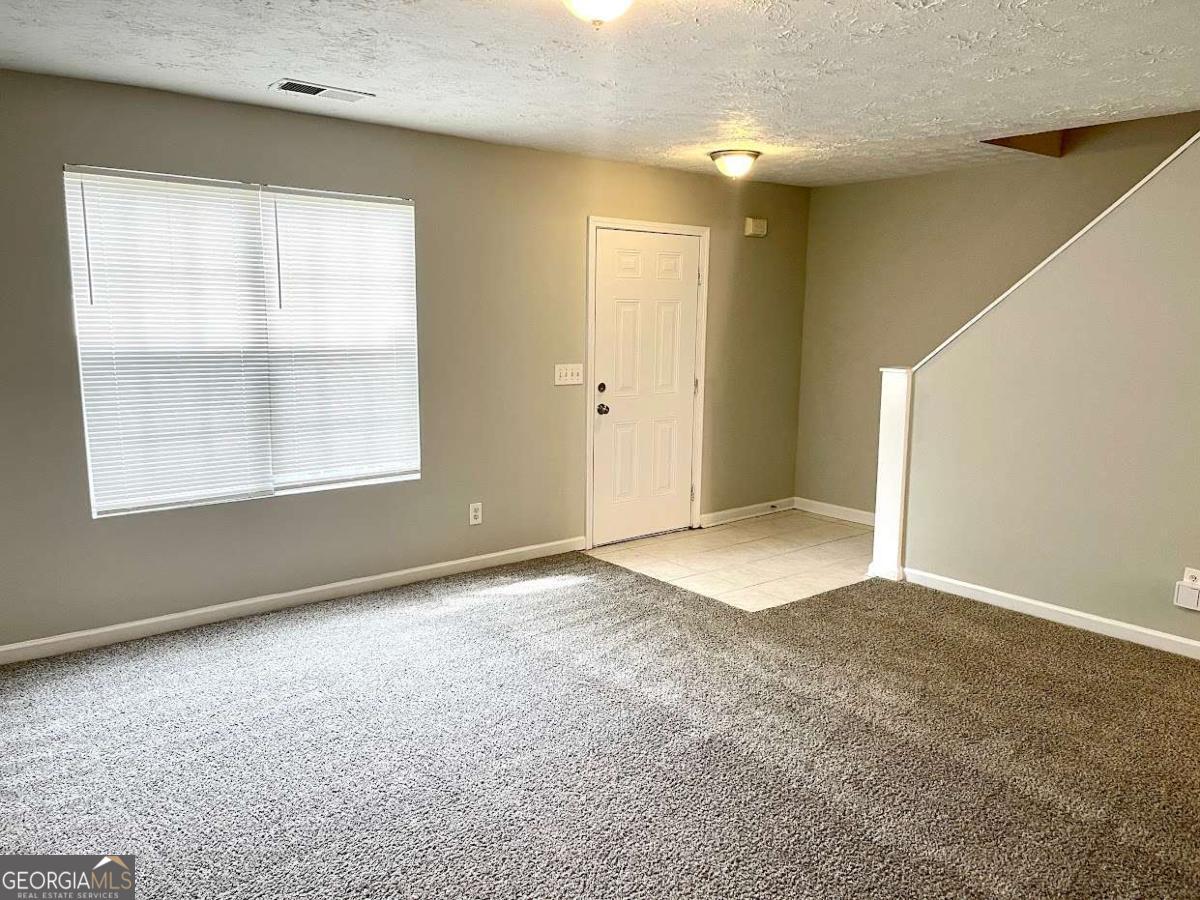 5594 Fair Creek Way Lithonia, GA 30038 - Photo 2 of 15 an empty room with windows and closet