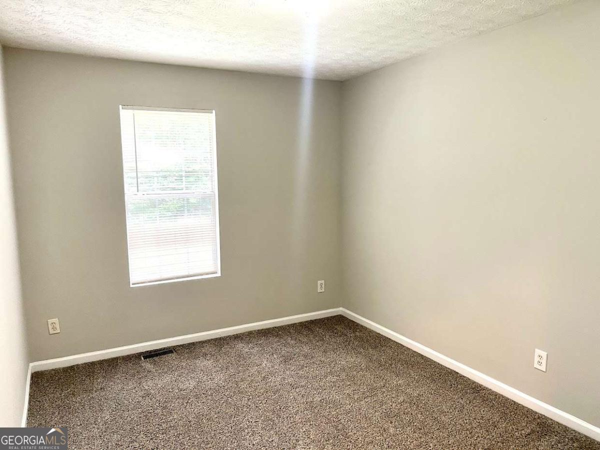5594 Fair Creek Way Lithonia, GA 30038 - Photo 8 of 15 an empty room with a window