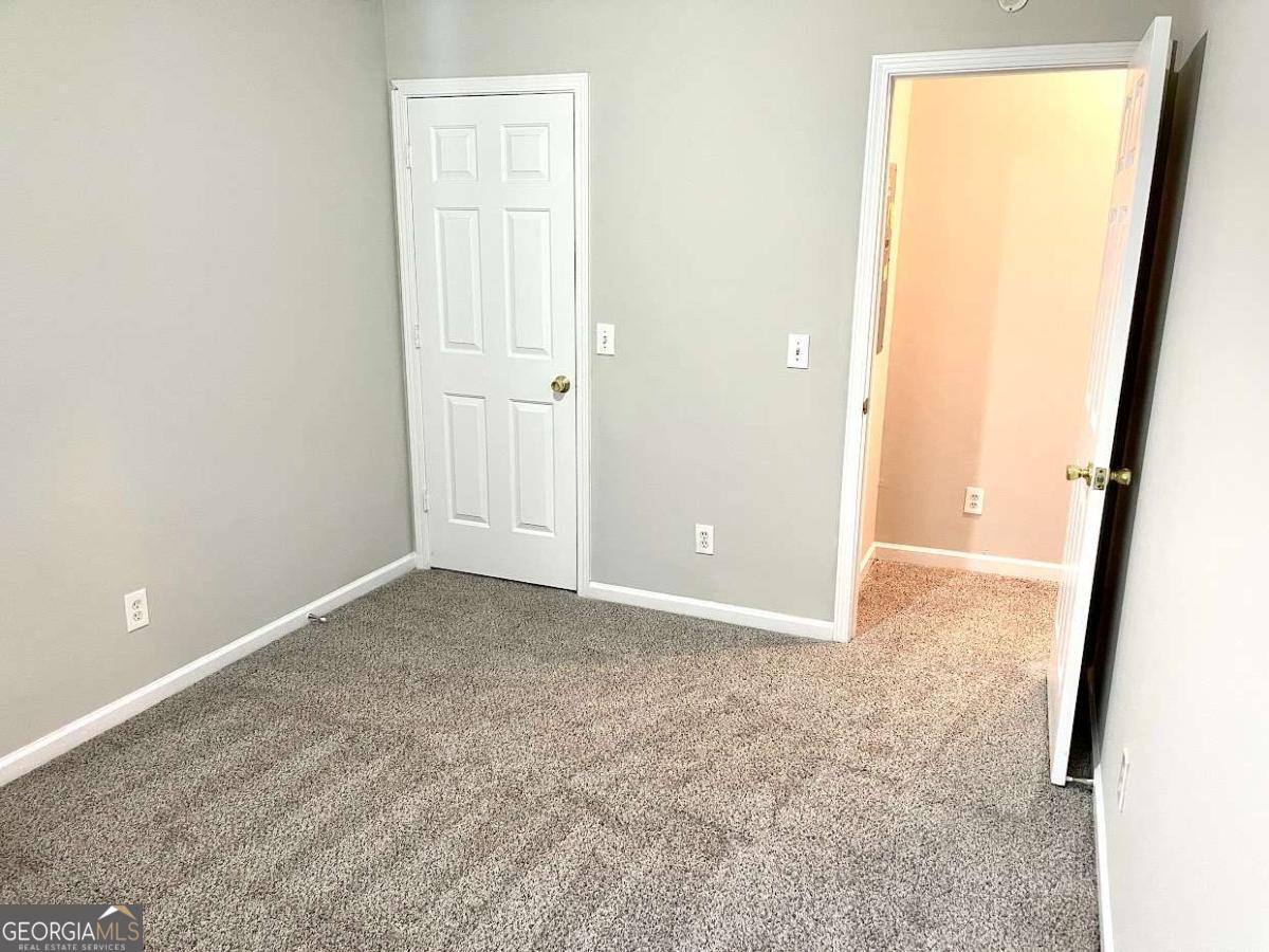 5594 Fair Creek Way Lithonia, GA 30038 - Photo 9 of 15 an empty room with windows