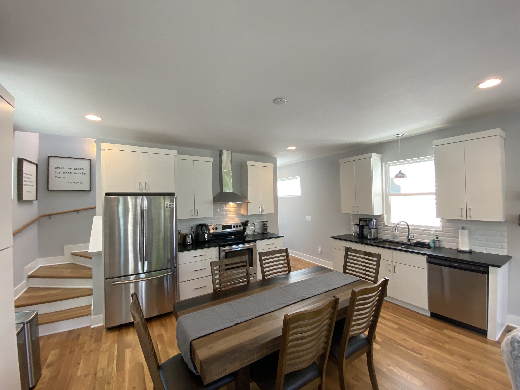 200 B Sunset Drive Nashville, TN 37207 - Photo 9 of 31 a kitchen with stainless steel appliances a refrigerator a stove a sink a dining table and chairs