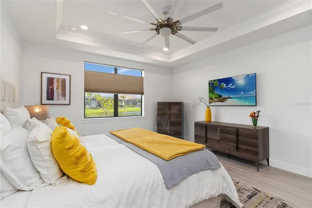 a bedroom with a bed and a painting on the wall