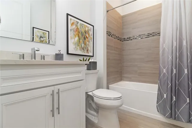 an aerial view of a house with a garden and lake view