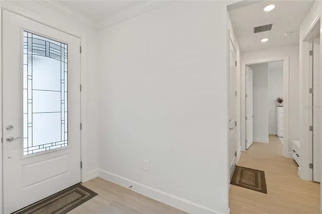 a view of a dining room and livingroom with furniture wooden floor a chandelier