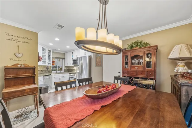 a living room with furniture a table and kitchen view