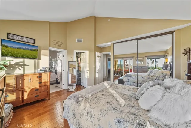 a bedroom with a large bed and a large window