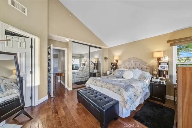 a bedroom with a large bed and a dresser