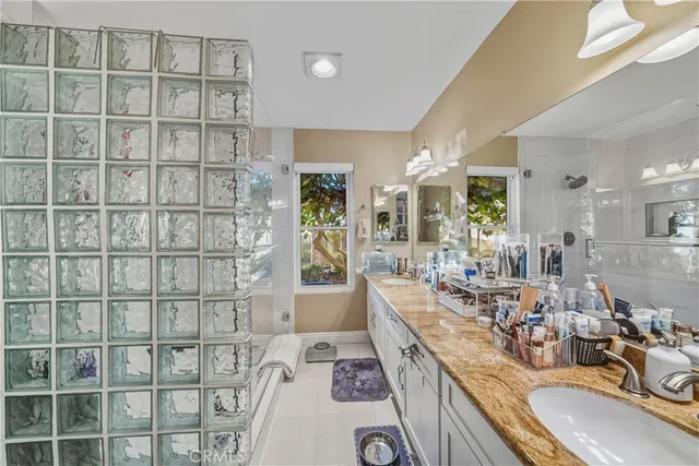 a spacious bathroom with a granite countertop tub sink and mirror