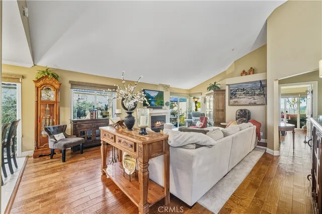 a living room with fireplace furniture and a large window