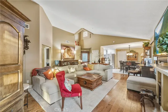 a living room with furniture dining area and a large window