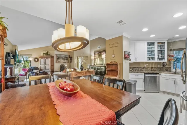 a kitchen with stainless steel appliances granite countertop a stove and a view of living room