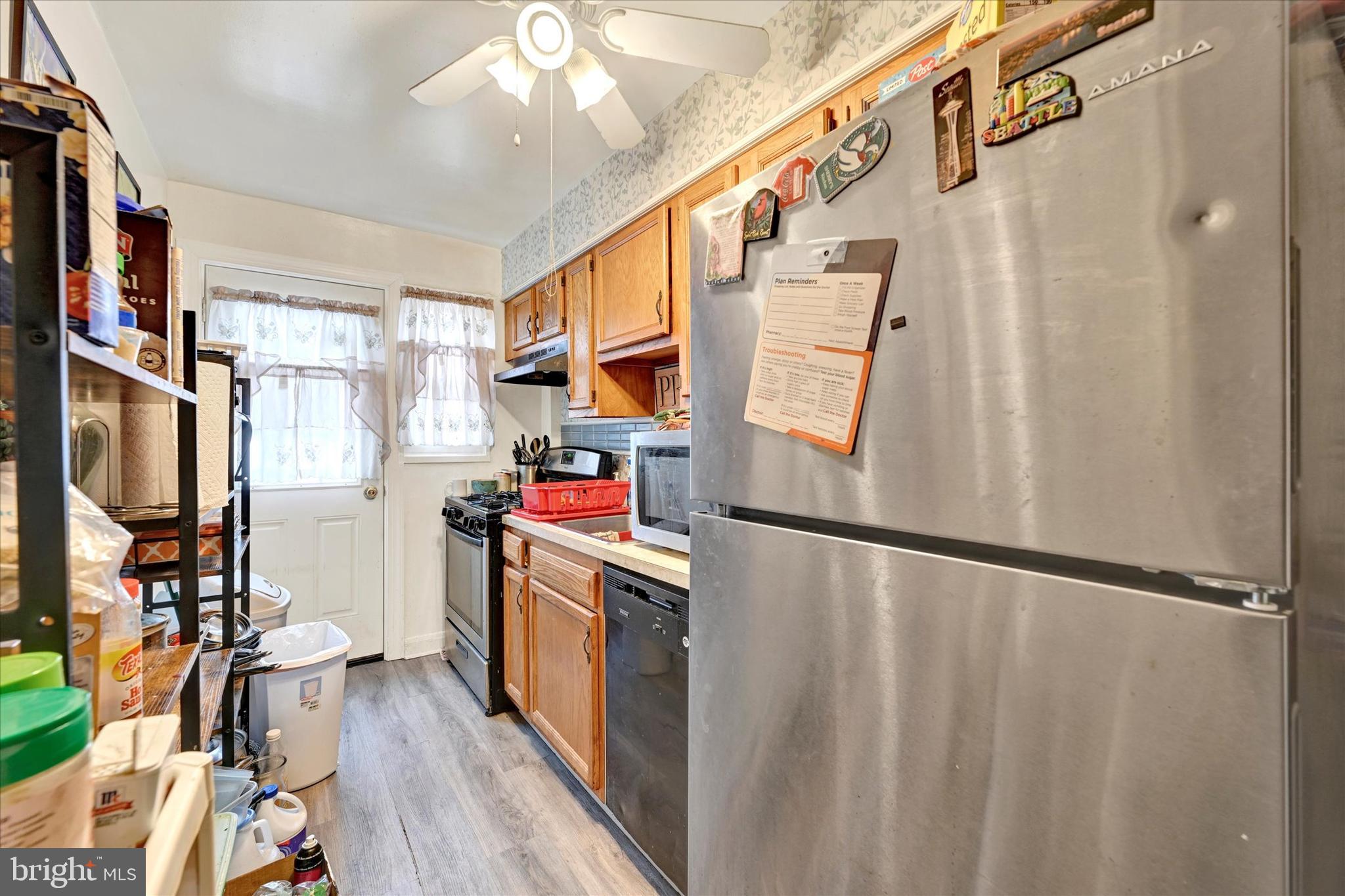 517 Random Road Baltimore, MD 21229 - Photo 4 of 13 a view of walk in closet with clothes and shoes