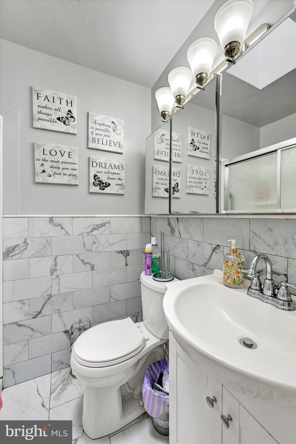 517 Random Road Baltimore, MD 21229 - Photo 10 of 13 a bathroom with a sink mirror and toilet