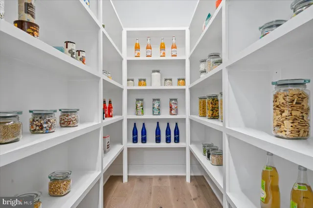 a living room with lots of wooden furniture and a chandelier