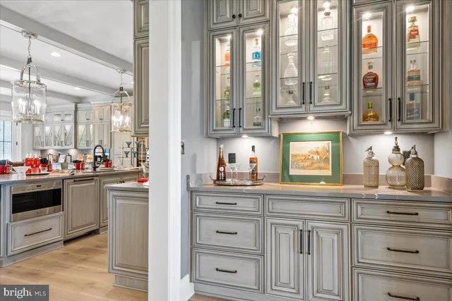 a living room with furniture a fireplace and a chandelier