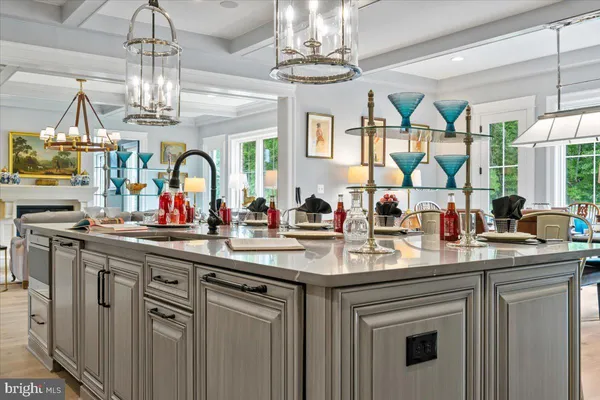 a kitchen with center island a sink cabinets and a chandelier