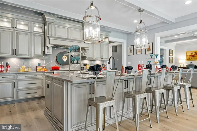 a kitchen with center island a sink cabinets and a chandelier