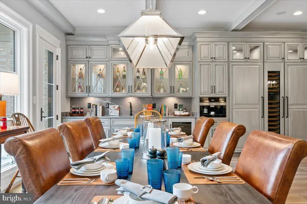 a living room with furniture a large window and chairs