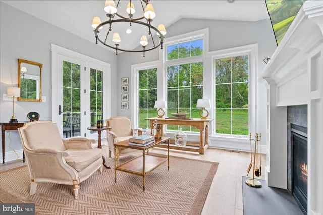 a living room with furniture a large window and chairs