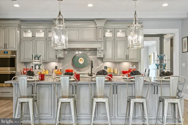a living room with lots of wooden furniture and a chandelier